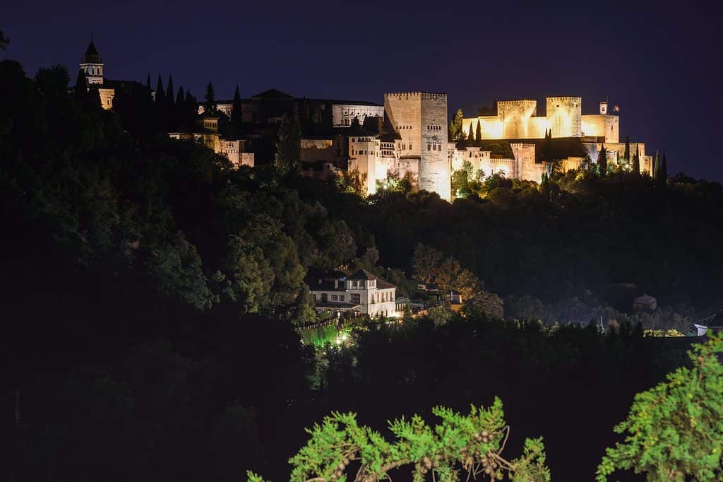 View of the famous Alhambra palace in Granada from Sacromonte quarter, Spain. Night photograph.